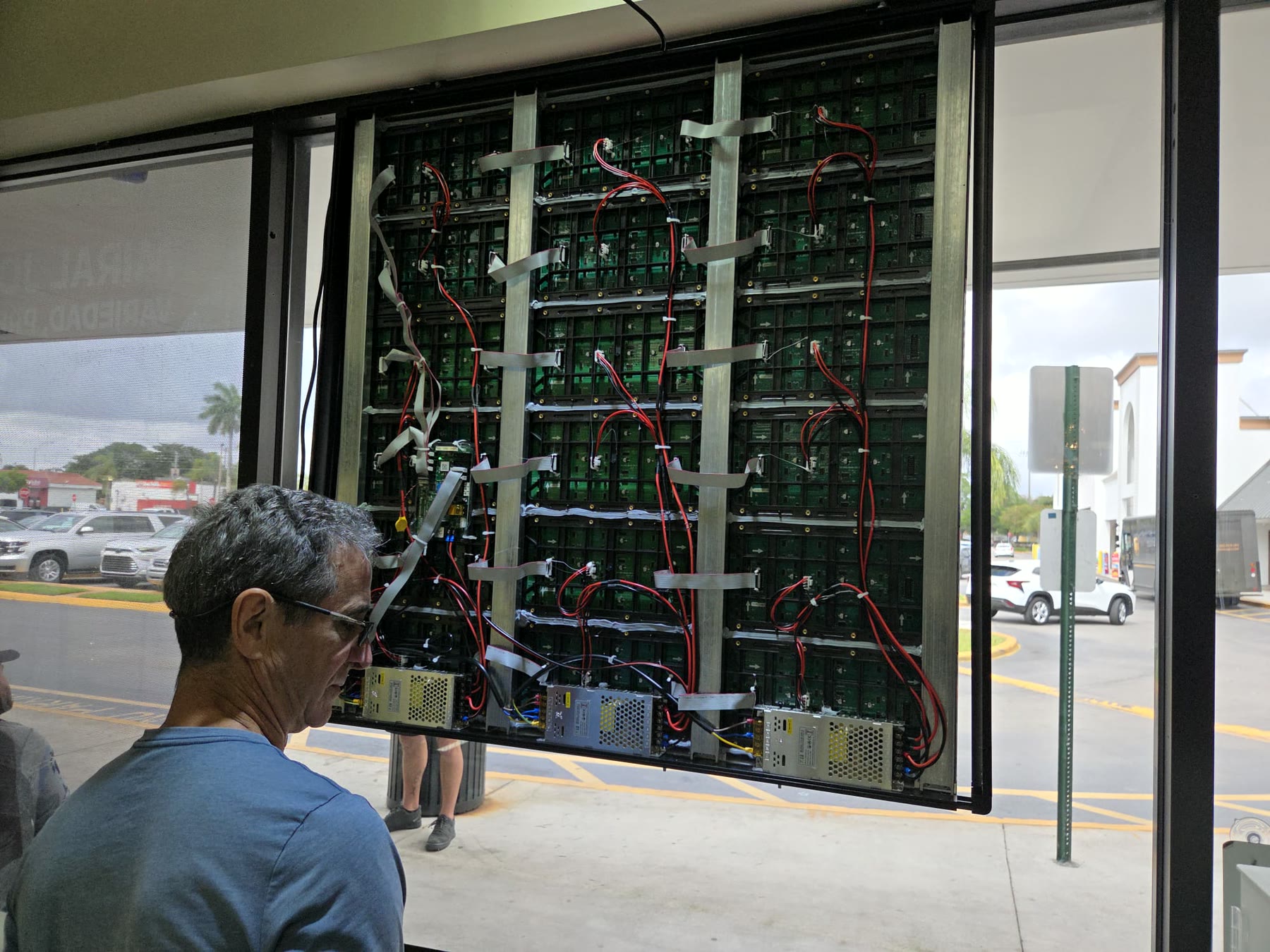 Technician assembling an array of LED display cabinets