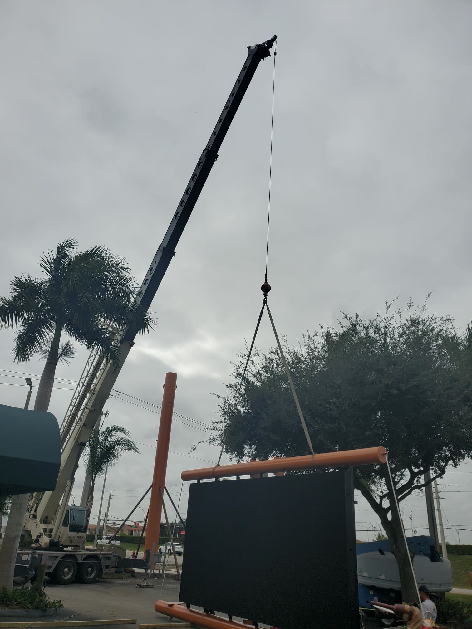 Crane lifting an LED display structure into place during installation