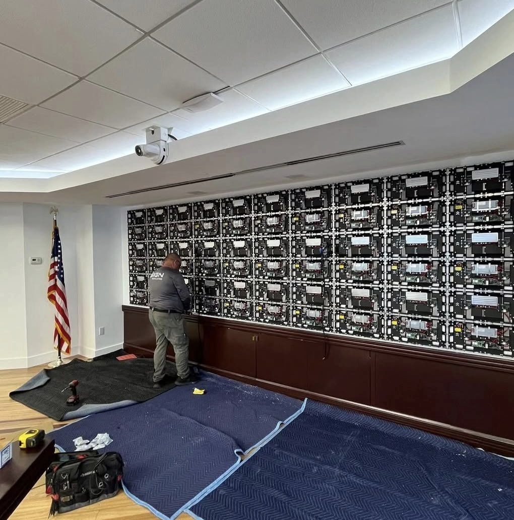 Ultra LED technicians installing a fine-pitch LED cabinet array in the Ocean Bank lobby